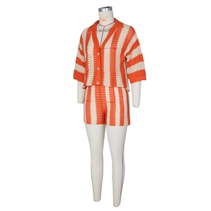 Close-up of orange and beige striped crochet knit shorts set with intricate hollow out details
