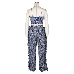 Detailed back view of jacquard crop top with cross-lace ties and tassel-trimmed trousers