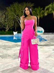 Sexy hot pink strapless cargo jumpsuit with wide legs and utility pockets for party wear