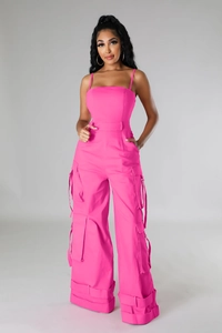 Detailed view of hot pink strapless cargo jumpsuit with utility pockets and ribbons