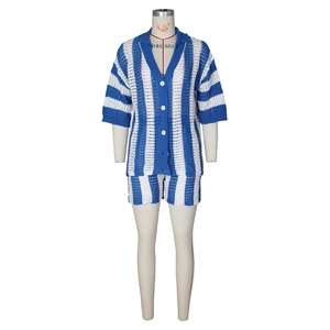 Detail of blue and white striped knit set with hollow-out texture and buttons