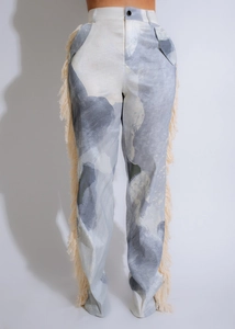 Detail of high waist trousers featuring abstract grey print and side tassel fringe details