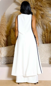 Detail of white sleeveless vest dress with black piping and side lace-up design for women