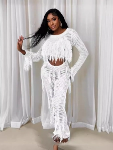 White crochet knit two-piece set with long sleeve top, tassel pants, and hollow-out design