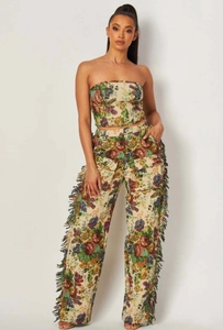 Detail showing jacquard floral pattern and side fringe tassels on high waist wide leg pants