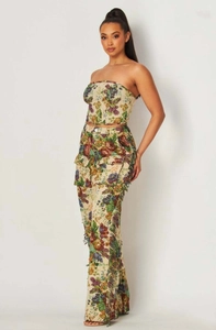 Detail view of floral jacquard fabric and side tassel fringe on high waist trousers