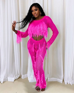 Detail showing bright pink crochet texture and faux feather tassels on two-piece knit set