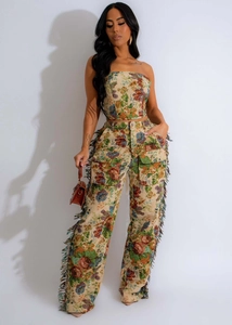 Detail of floral jacquard fabric and colorful side fringe on high-waisted wide-leg trousers