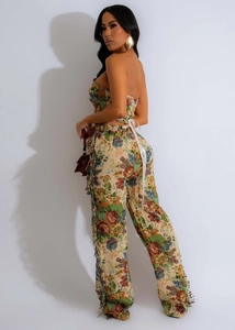 Detail of floral two-piece set featuring lace-up back top and fringe wide-leg trousers