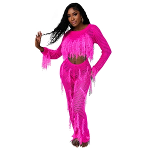 Detail of rose pink knit two-piece set featuring faux fur fringe and intricate crochet texture