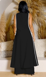 Detail showing white piping on sleeveless black dress with a relaxed back design