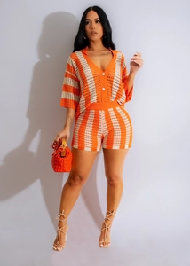 Detail of orange and white striped crochet two-piece knit set with deep V-neck and high waist