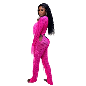 Detailed texture of hot pink crochet knit set with fringes and cutout side mesh panels
