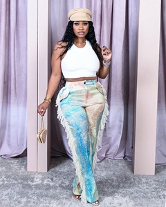 Detail of colorful tie-dye straight pants with long tassels and bohemian fringe texture
