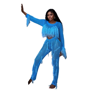 Close-up of blue hollow-out knit fabric with long tassels on a two-piece set