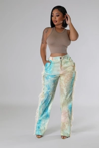 Detail view of colorful tie-dye casual pants featuring white fringe trim along the side seams