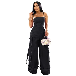 Detail view of black strapless cargo jumpsuit featuring side flap pockets and wide leg cut