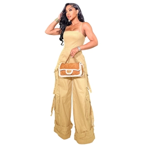 Detail of khaki cargo jumpsuit featuring functional side pockets and wide leg cut