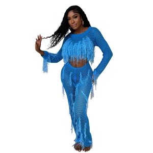 Detail of blue crochet knit hollow-out fabric with feather tassel trim decorations