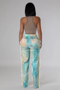 Rear view of women's wide leg pants featuring colorful tie-dye print and side fringe details