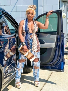 Street style view of a sexy backless halter top made of striped neckties and ripped jeans