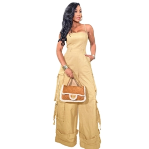 Detail view of khaki strapless utility jumpsuit with large side pockets and drawstring hem