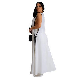 Detail view of the side cutout with black bows on a white sleeveless maxi dress