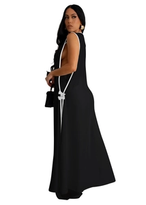 Close-up of black sleeveless maxi dress with white bow detail and side slit