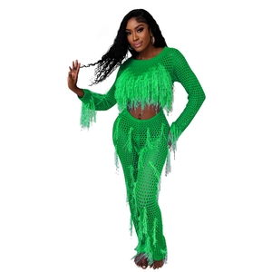 Detail view of neon green crochet knit set featuring long fringe tassels and mesh texture