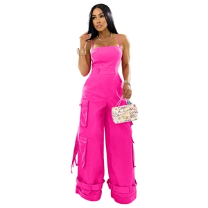 Detail view of pink strapless utility jumpsuit featuring side cargo pockets and straps
