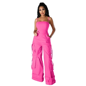 Detailed view of the multi-pocket cargo design and straps on pink wide-leg jumpsuit