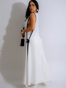 Elegant white sleeveless maxi dress with deep V-neck and black bow side accents