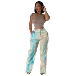 Detail of colorful marble print casual trousers with white fringe trim on the leg side