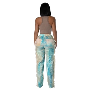 Rear view of casual pants featuring artistic dye patterns and side fringe details