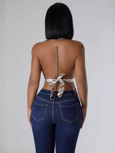 Sexy backless halter top with striped tie-back detail and slim-fit denim jeans