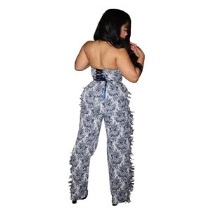 Detail of blue and white floral jumpsuit featuring back lace-up closure and side fringes