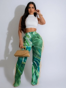Women's chic white knit crop top and green abstract print wide-leg trousers with fringe