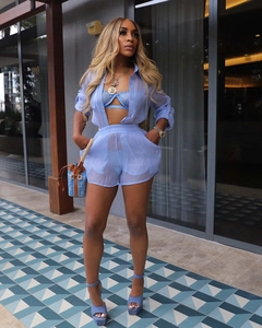 Detail of sheer blue long sleeve shirt and shorts set styled with a matching lace bra