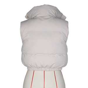 Rear view of light beige quilted vest with stand collar and adjustable hem on mannequin
