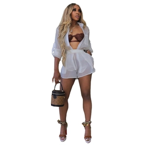 Detail of white sheer long sleeve shirt and elastic shorts with lightweight chiffon texture