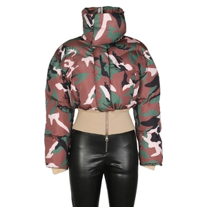Detailed close-up of a women's camouflage puffer jacket and black faux leather pants
