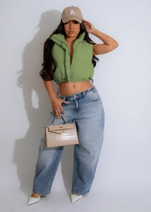 Fashionable grass green stand-up collar puffer vest paired with light blue high-waisted jeans