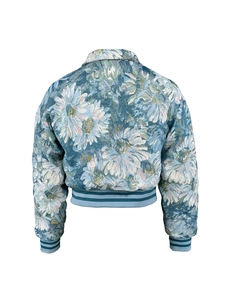 Detailed back view of vintage blue floral bomber jacket with white daisy pattern