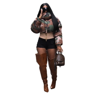 Short camo puffer jacket with high collar paired with black denim shorts and tall boots