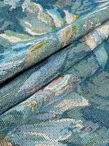 Close-up of vintage floral jacquard fabric texture on a long-sleeve jacket