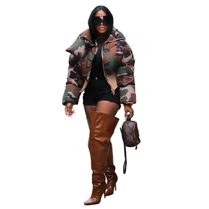 Fashionable women's camouflage puffer jacket styled with high brown leather boots
