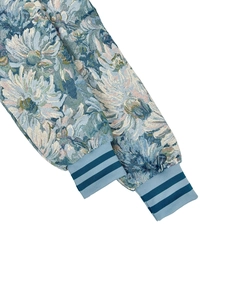 Detailed macro view of floral tapestry jacquard fabric with striped ribbed cuffs on the jacket