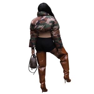 Back view of women's camo puffer jacket paired with high boots and mini backpack