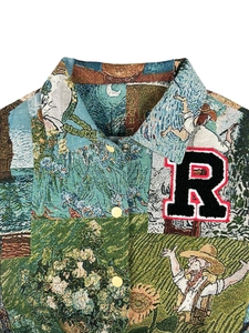 Macro detail of tapestry jacket fabric with vintage pattern and large 'R' letter patch