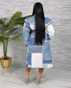 Detail view of denim patchwork print on a double-breasted long cotton jacket for women
